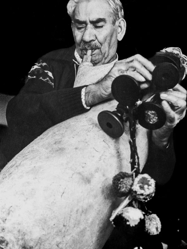 Man playing a traditional bagpipe.