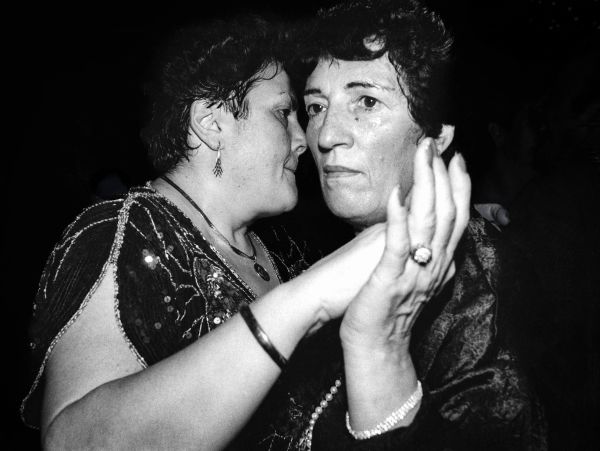 Two women dancing closely in a black and white photo.