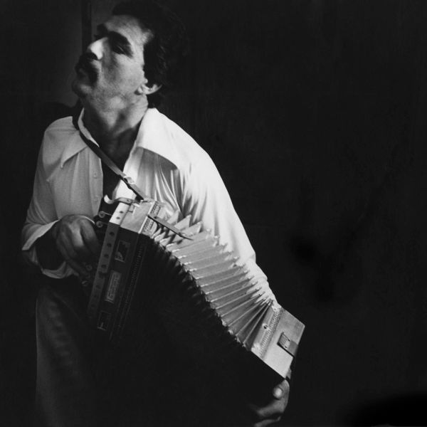Man playing an accordion passionately.