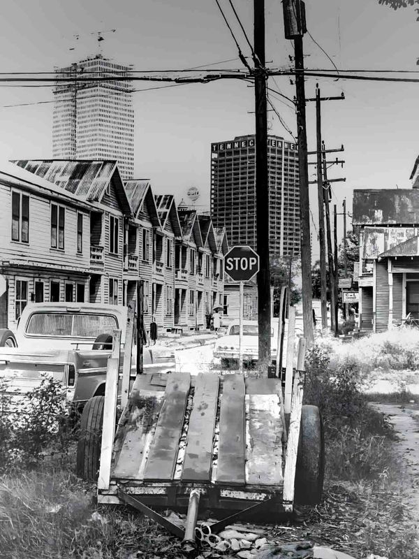 Old wooden trailer in an urban alley with stop sign.