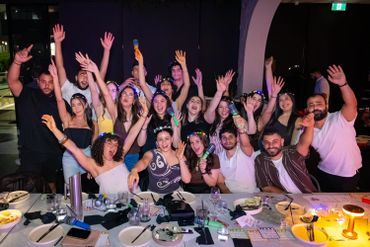 Group of friends celebrating together at a lively dinner party.