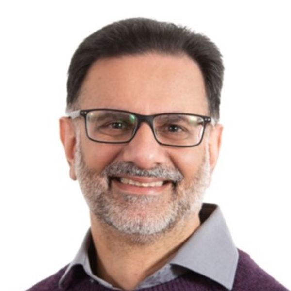 Smiling middle-aged man with glasses and a beard.