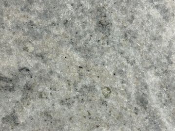 Close-up of gray granite stone surface with fine speckled texture.