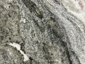 Close-up of textured gray and white marble surface with natural patterns.