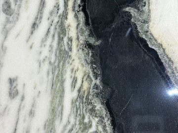 Close-up of a textured black and white marble surface with intricate patterns.