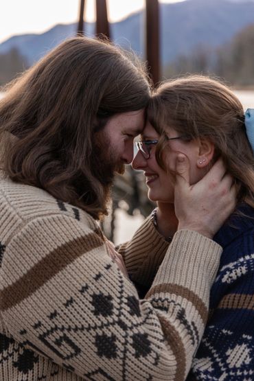 Couple sharing an intimate forehead touch outdoors.