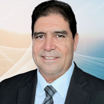 Portrait of a smiling man in a suit and tie.