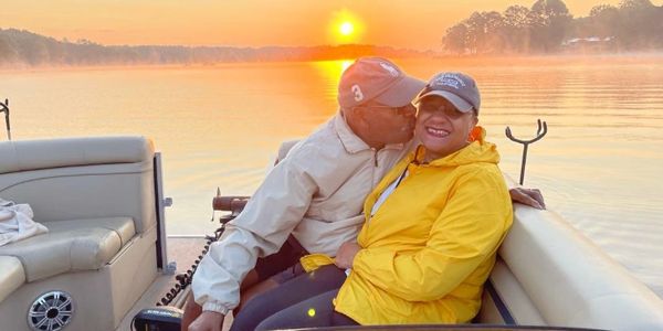 Couple enjoying a boat ride at sunrise.