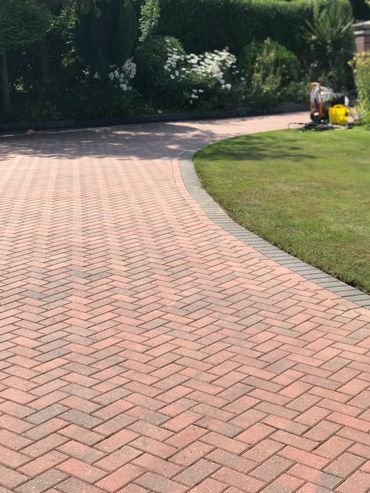 Driveway pressure washing and re-sanding.