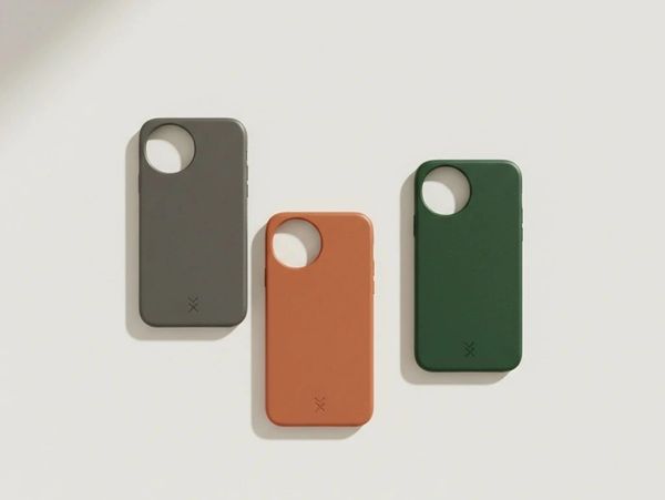 Three minimalistic phone cases in gray, orange, and green on a white surface.
