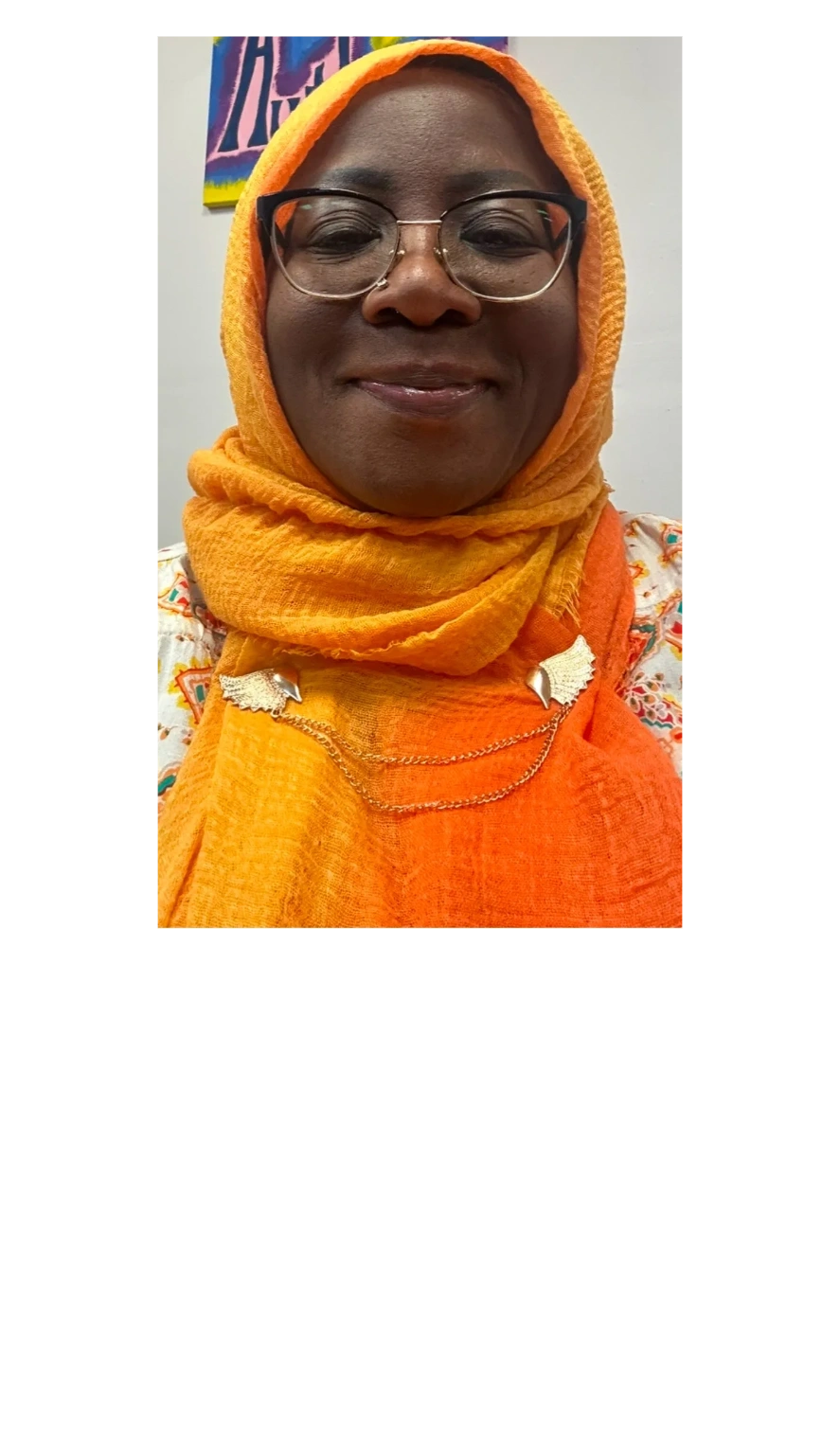 A woman wearing eyeglass and looking ahead on the camera