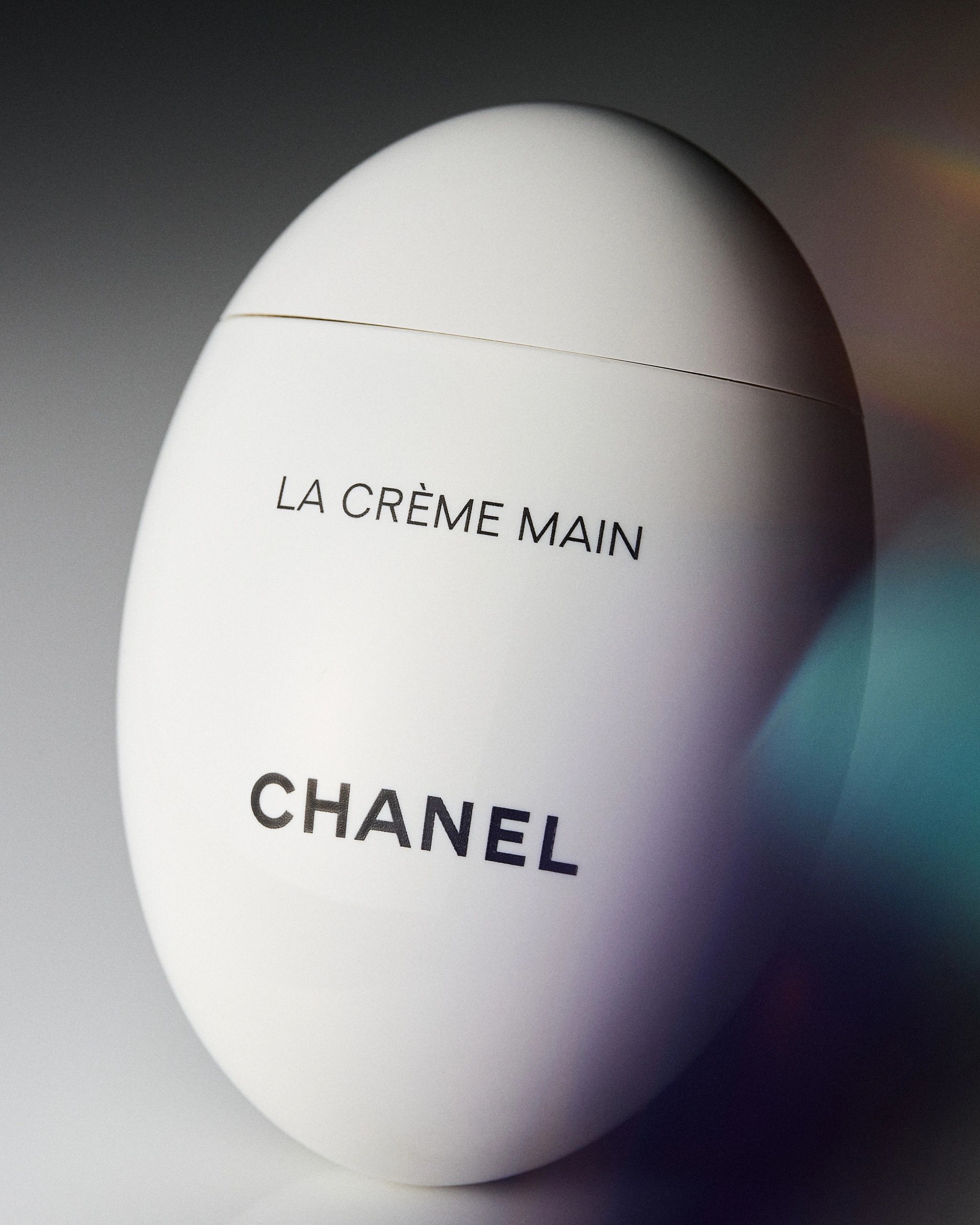 Close-up of Chanel La Crème Main hand cream container.