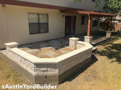 Flagstone Patio backyard designs with White Limestone Sitting Wall and a Cedar Wood Pergola.