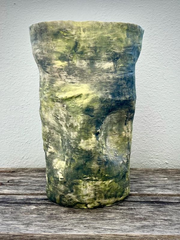 Handcrafted ceramic vase with textured green and yellow glaze.