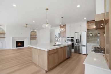 Modern kitchen with a large island and stainless steel appliances.