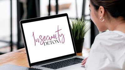 Woman looking at 'Insecurity Detox' on laptop.