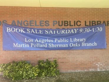 Banner for a book sale at Los Angeles Public Library Sherman Oaks branch.