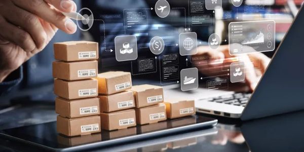 Stacked packages and digital logistics icons beside a laptop.