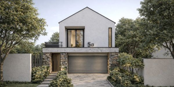 Modern two-story house with stone accents and a large garage door.