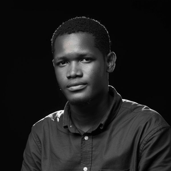 Black and white portrait of a young man with a calm expression.