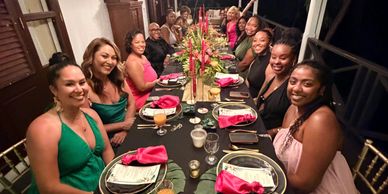 A group of people gathered around a decorated dinner table.
