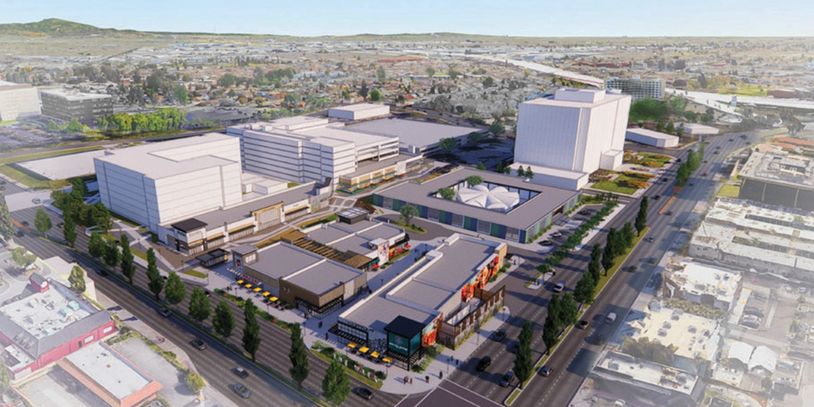Aerial view of a large urban commercial and office complex with multiple buildings and parking areas.