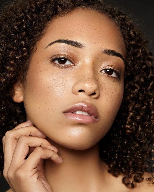 Models makeup is minimal, featuring neatly defined eyebrows, soft eyeshadow, and a light lip gloss.
