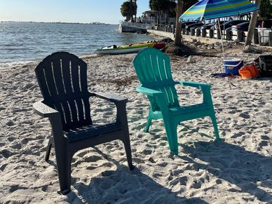 2 beach chairs on the sand on tampa bay beach. www.whatsuppaddlesports.com