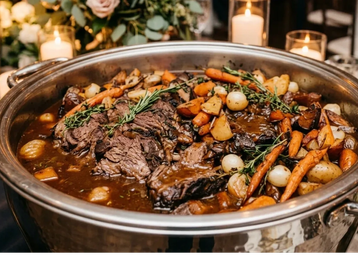 Pot roast with vegetables in a serving dish.