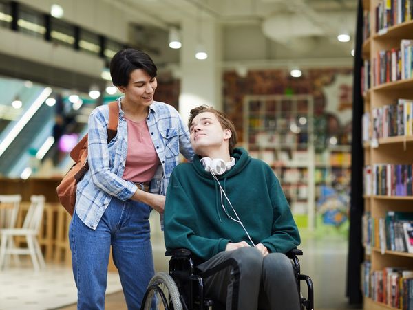 A carer with a patient in a wheel chair