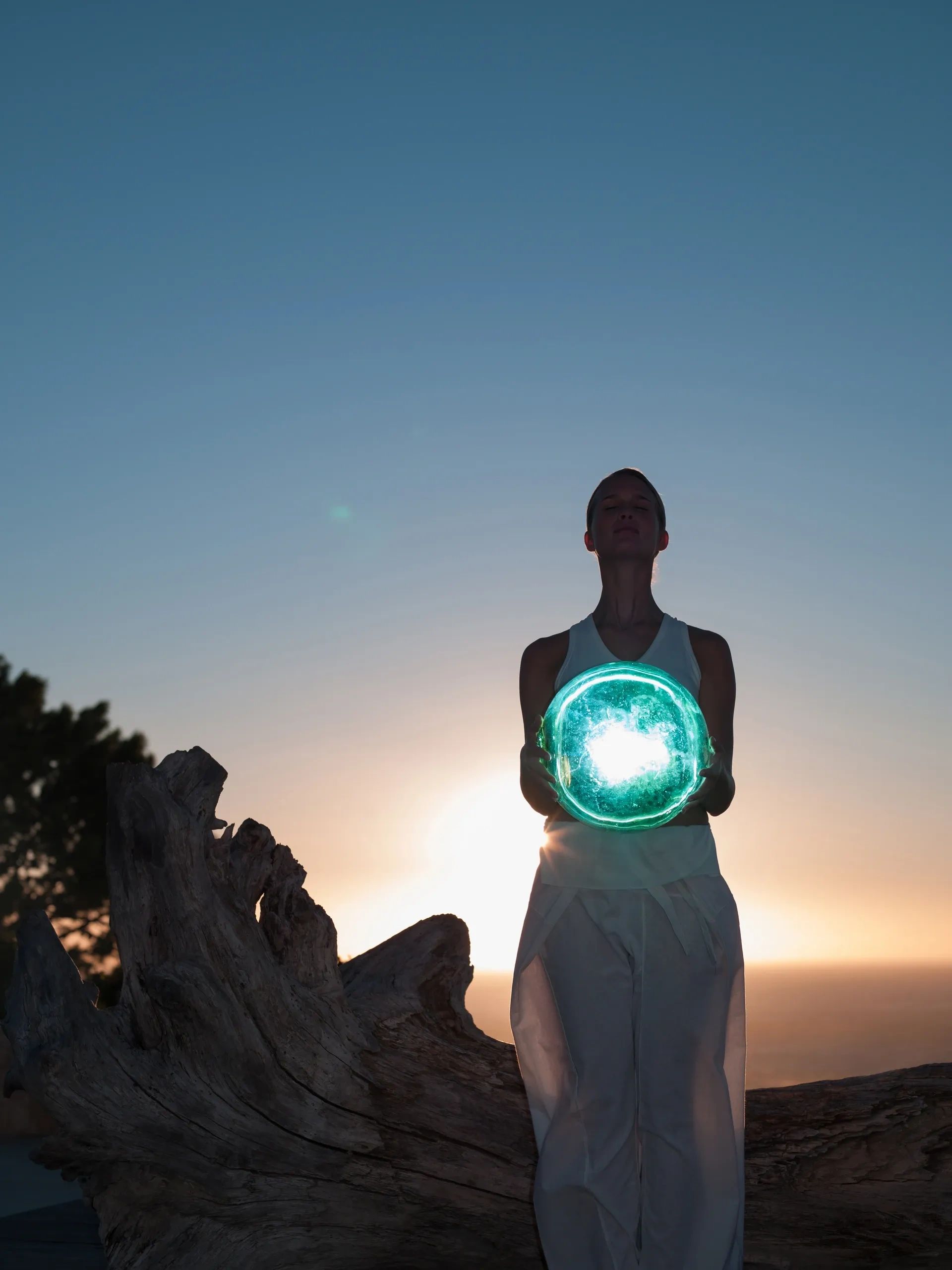 Person holding a glowing blue orb.