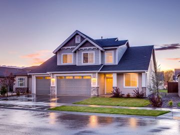 A modern two-story house at dusk.