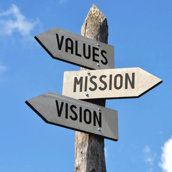 A sign with three different arrows pointing in different directions that read values mission vision