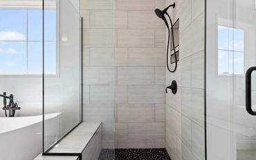 Beautiful walk-in shower with bench and glass shower door in a new house in Mechanicsburg, PA