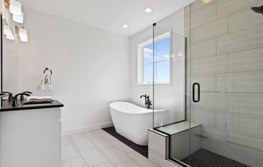 A newly remodeled bathroom with tile shower, new vanity and soaking tub in Harrisburg, PA