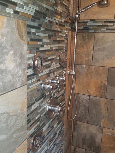 Newly installed body sprays in a tile shower in a remodeled bathroom located in Central PA