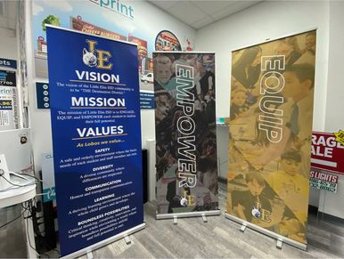 Three custom retractable banner stands for Little Elm ISD, featuring Vision, Mission, Values, and Em