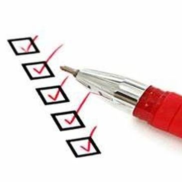 Red pen marking checkboxes on a checklist.