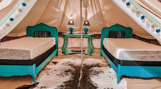 Two beds inside one of the tents located in Glamp Inn.