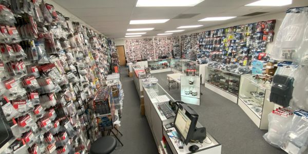 Interior of a hobby or model store filled with packaged items and display cases.