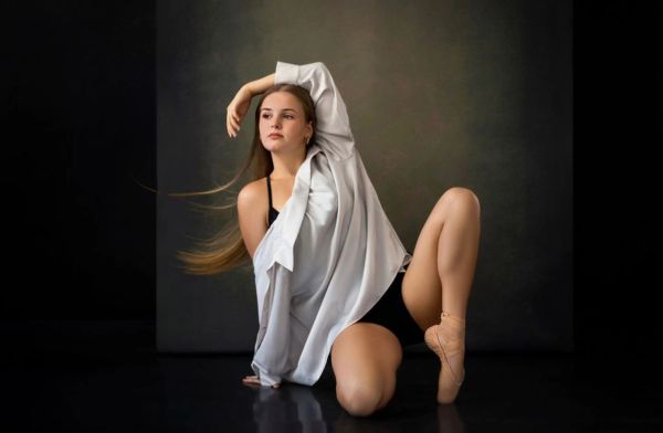 Ballerina posing gracefully in a studio.