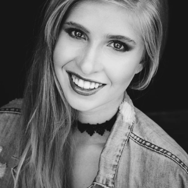 Black and white portrait of a smiling woman.