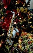 Free Christmas Saxophone Wallpaper / Screensavers - Dark Picture - For Cell Phones - White Yamaha Alto Sax under the tree.
