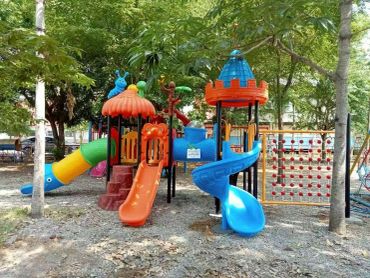 Colorful playground with slides and climbing structures in a park.