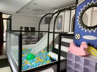 Indoor ball pit and slide play area for children.