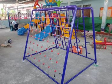 Indoor playground with slides and climbing ropes under construction.