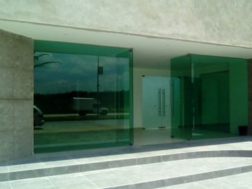 Modern building entrance with large glass doors and steps.