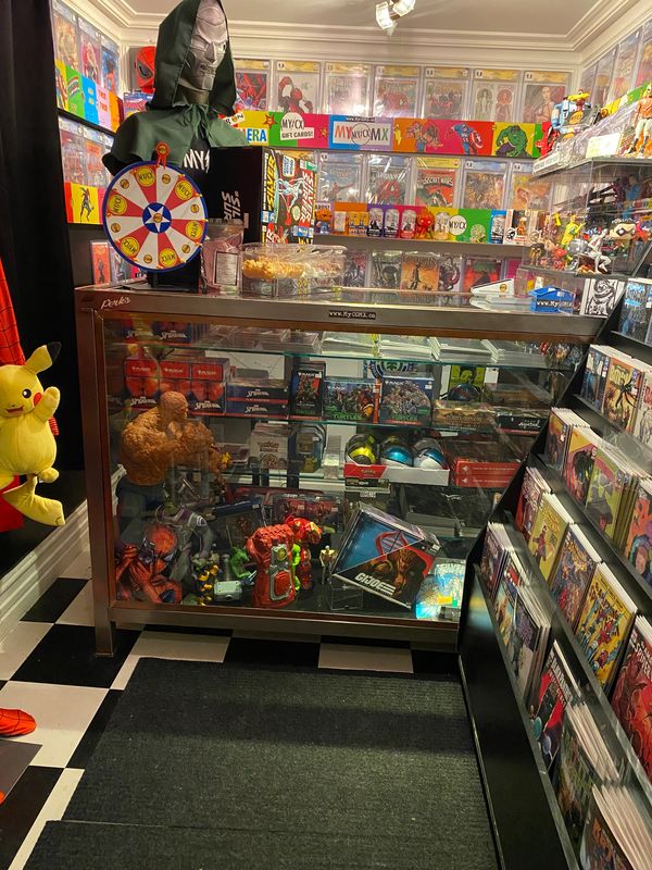 A comic book store corner filled with collectibles, comics, and toys.