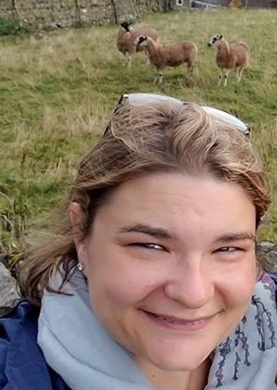 Veterinarian Dr. Mackenzie Hellert with sheep behind her