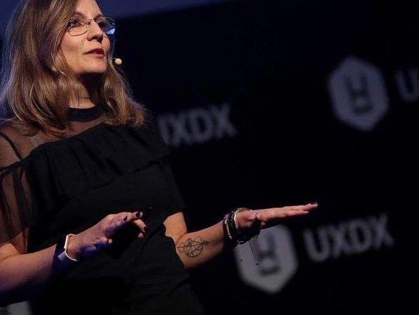 Woman speaker giving a presentation at a UXDX event.
